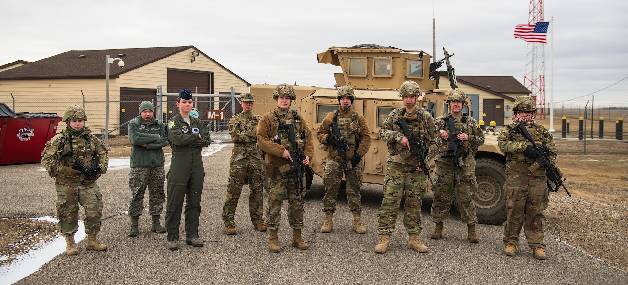 All-Female Alert Airmen from Minot Air Force Base pose in front of a High Mobility Multipurpose Wheeled Vehicle at a Missile Alert facility near Minot, North Dakota, March 12, 2020. The Airmen took part in an all-female alert crew in observance of Women's History Month. (U.S. Air Force photo by Airman Fist Class Jesse Jenny)