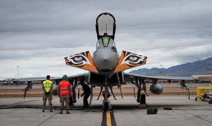 Airman prep jet for takeoff.