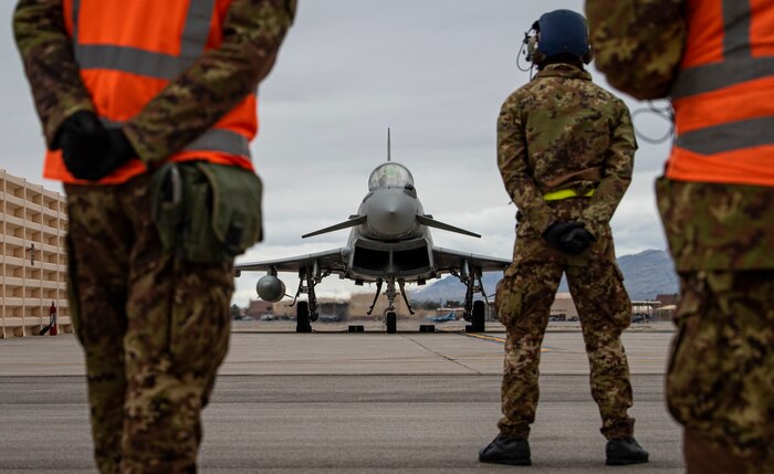 Airman stand on the flight line.