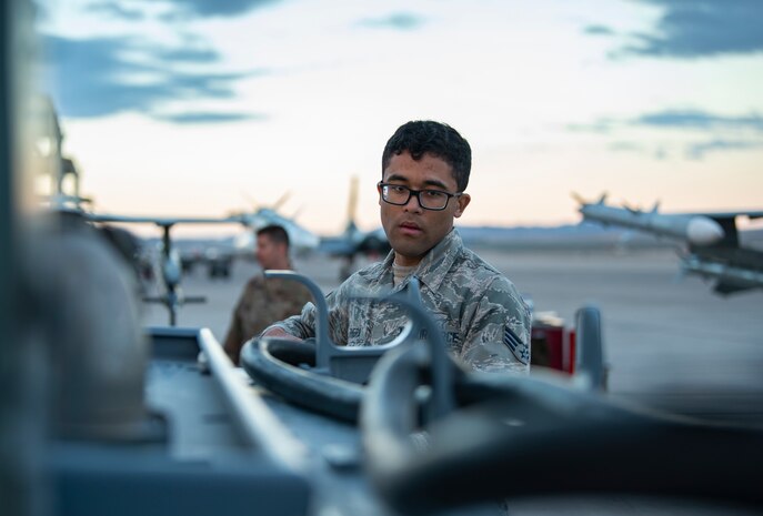 Airman wraps up a power cord.
