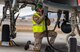 Airman connects a pump to a jet.