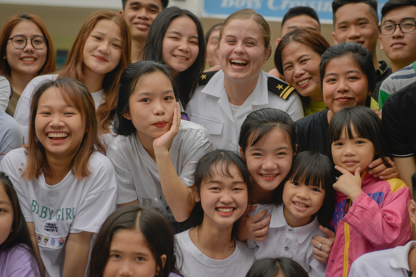 200306-N-YQ383-1088 VIETNAM (March 6, 2020) Lt. j.g. Courtney Avon, a public affairs officer, poses for a photo with children at the Dorothea’s Project Legacies Charity Center, Da Nang, Vietnam, during a community relations project organized by the aircraft carrier USS Theodore Roosevelt (CVN 71) March 6, 2020. Theodore Roosevelt and the Ticonderoga-class guided-missile cruiser USS Bunker Hill (CG 52) are in Vietnam for a port visit during their scheduled deployment to the Indo-Pacific.