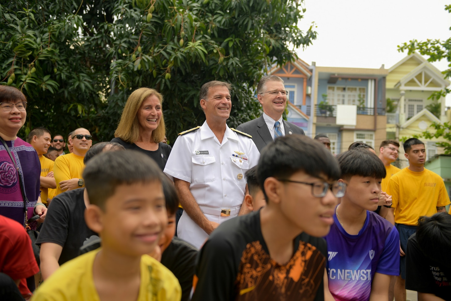 200306-N-YQ383-1183 VIETNAM (March 6, 2020) Laura Aquilino, left, Adm. John C. Aquilino, commander, U.S. Pacific Fleet, center, and U.S. Ambassador to Vietnam Daniel Kritenbrink watch a band performance at the Dorothea’s Project Legacies Charity Center, Da Nang, Vietnam, during a community relations project organized by the aircraft carrier USS Theodore Roosevelt (CVN 71) March 6, 2020. Theodore Roosevelt and the Ticonderoga-class guided-missile cruiser USS Bunker Hill (CG 52) are in Vietnam for a port visit during their scheduled deployment to the Indo-Pacific.