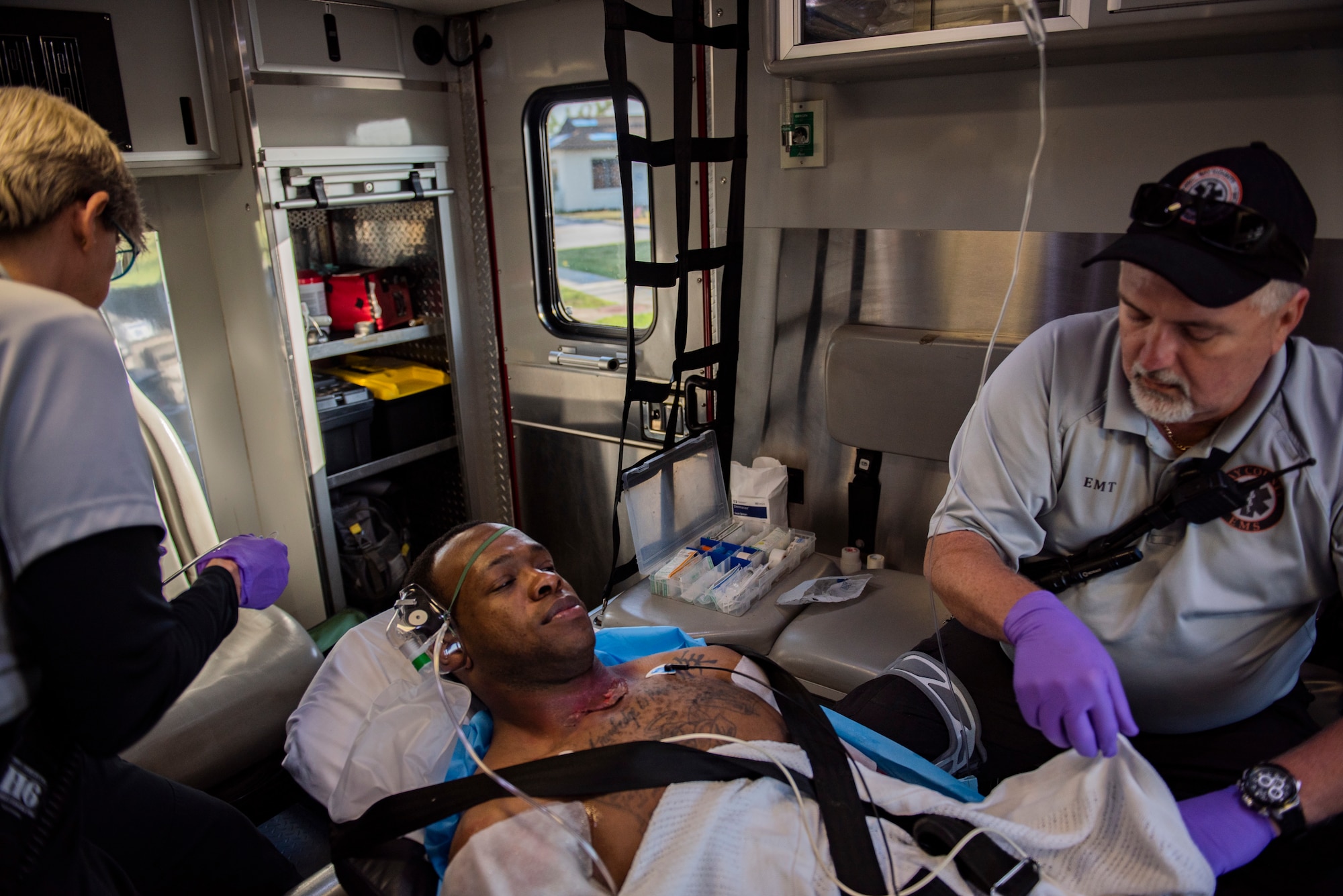 Kelly Guillory, Bay County Emergency Medical Services technician, left, Staff Sgt. Zachary Collins, 325th Operational Medical Readiness Squadron Ambulance Services Department technician, center, and Pete Russ, Bay County EMS technician, right, participate in a medical emergency exercise at Tyndall Air Force Base, Florida, March 12, 2020. Medical technicians and nurses participate in a joint medical exercise with the 325th Medical Group, Bay County EMS and Ascension Sacred Heart Bay Medical Center. (U.S. Air Force photo by Staff Sgt. Magen M. Reeves)