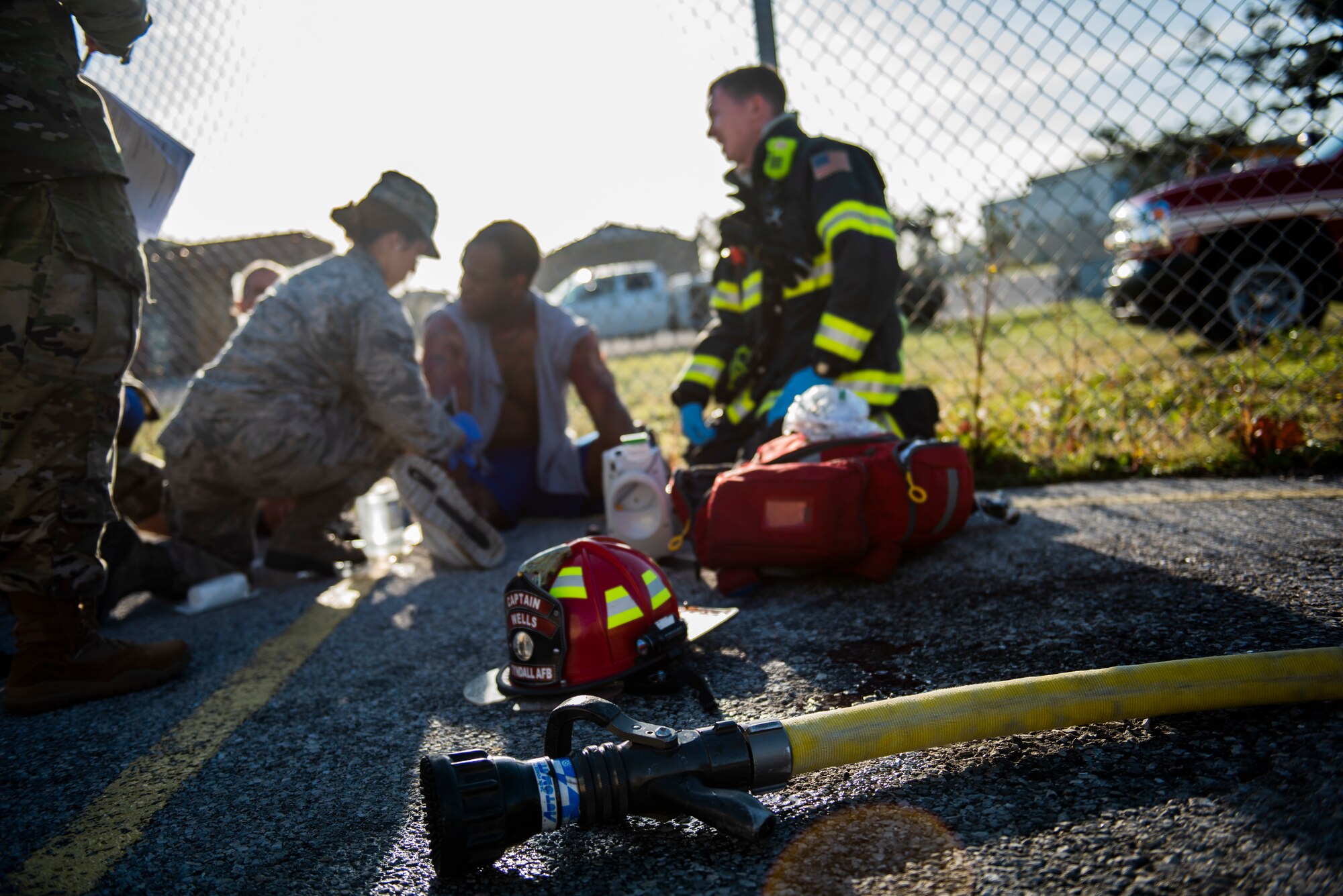 Senior Airman Ashley Deliz Aguilera, left, and Staff Sgt. Zachary Collins, center, 325th Operational Medical Readiness Squadron Ambulance Services Department technicians, participates in a medical emergency exercise at Tyndall Air Force Base, Florida, March 12, 2020. A joint medical exercise was conducted and included the 325th Medical Group, Bay County Emergency Medical Services and Ascension Sacred Heart Bay Medical Center. (U.S. Air Force photo by Staff Sgt. Magen M. Reeves)