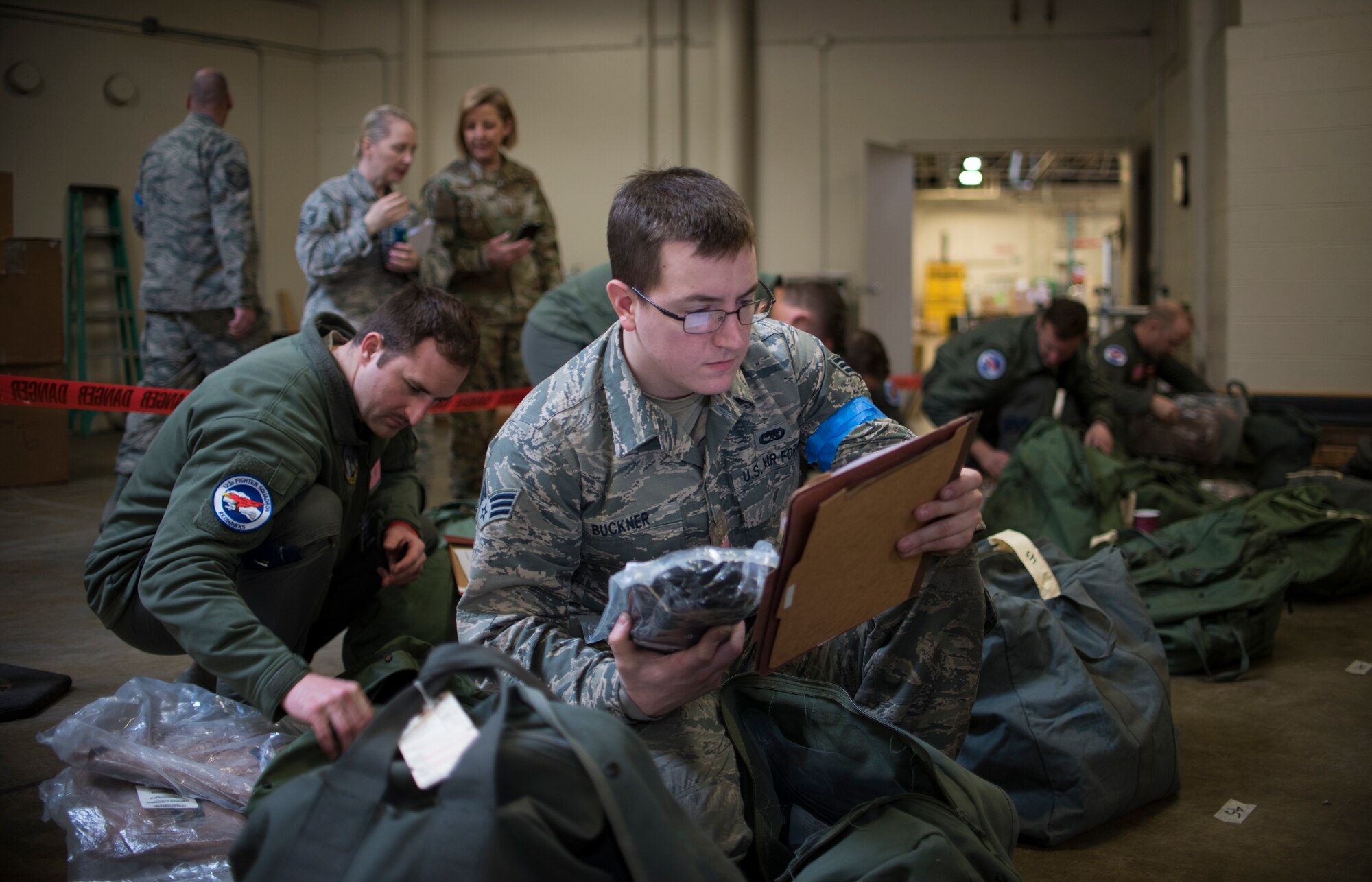 U.S. Air Force Senior Airman Brandon Buckner, assigned to the 142nd Fighter Wing's Maintenance Group, Oregon Air National Guard, reviews a packing list during deployment processing for a Combat Readiness Exercise March 7, 2020, Portland Air National Guard Base, Ore. The exercise simulated a mass deployment of approximately 700 members of the wing. (U.S. Air National Guard photo by Tech. Sgt. Steph Sawyer)