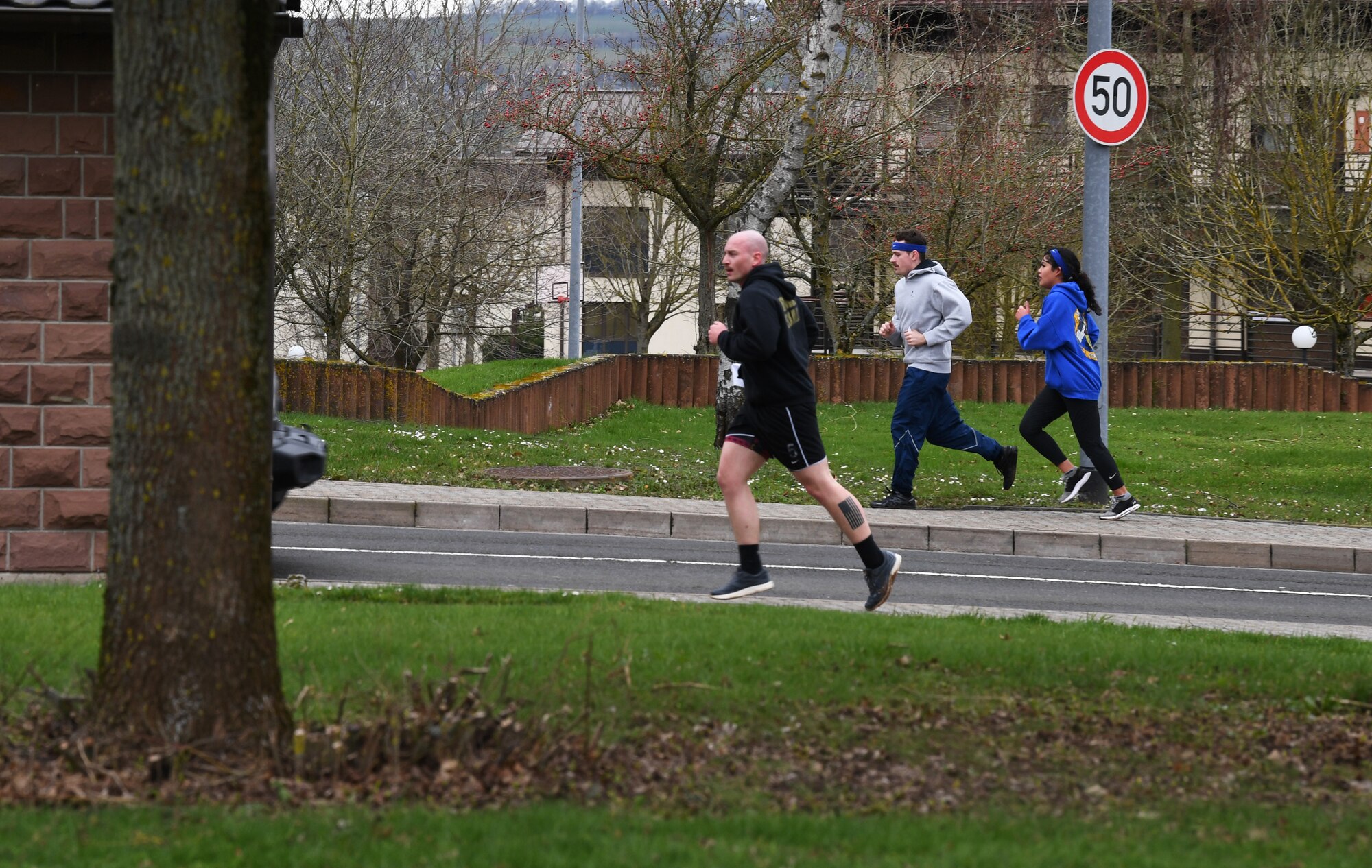 Participants of the "Run with Rosie" race run to the next location at Spangdahlem Air Base, Germany, March 12, 2020. The race consisted of clues and trivia that led participants to different locations around the base. (U.S. Air Force photo by Airman 1st Class Alison Stewart)