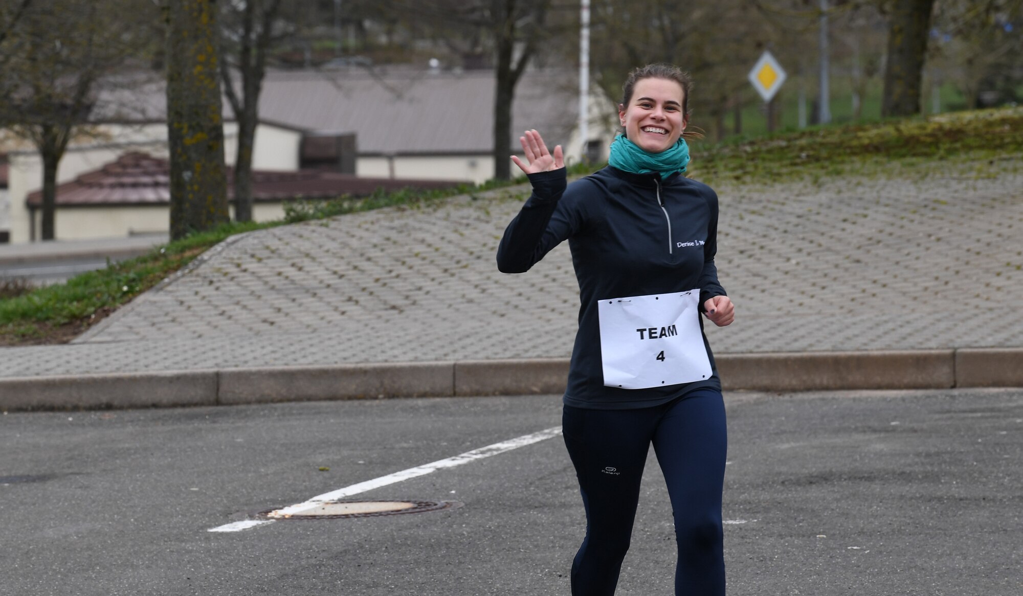 Denise Wilson, 52nd Force Support Squadron Human Resource specialist, waves at the camera during the "Run with Rosie" race event at Spangdahlem Air Base, Germany, March 12, 2020. Wilson and her teammate came in first place in the competition. (U.S. Air Force photo by Airman 1st Class Alison Stewart)
