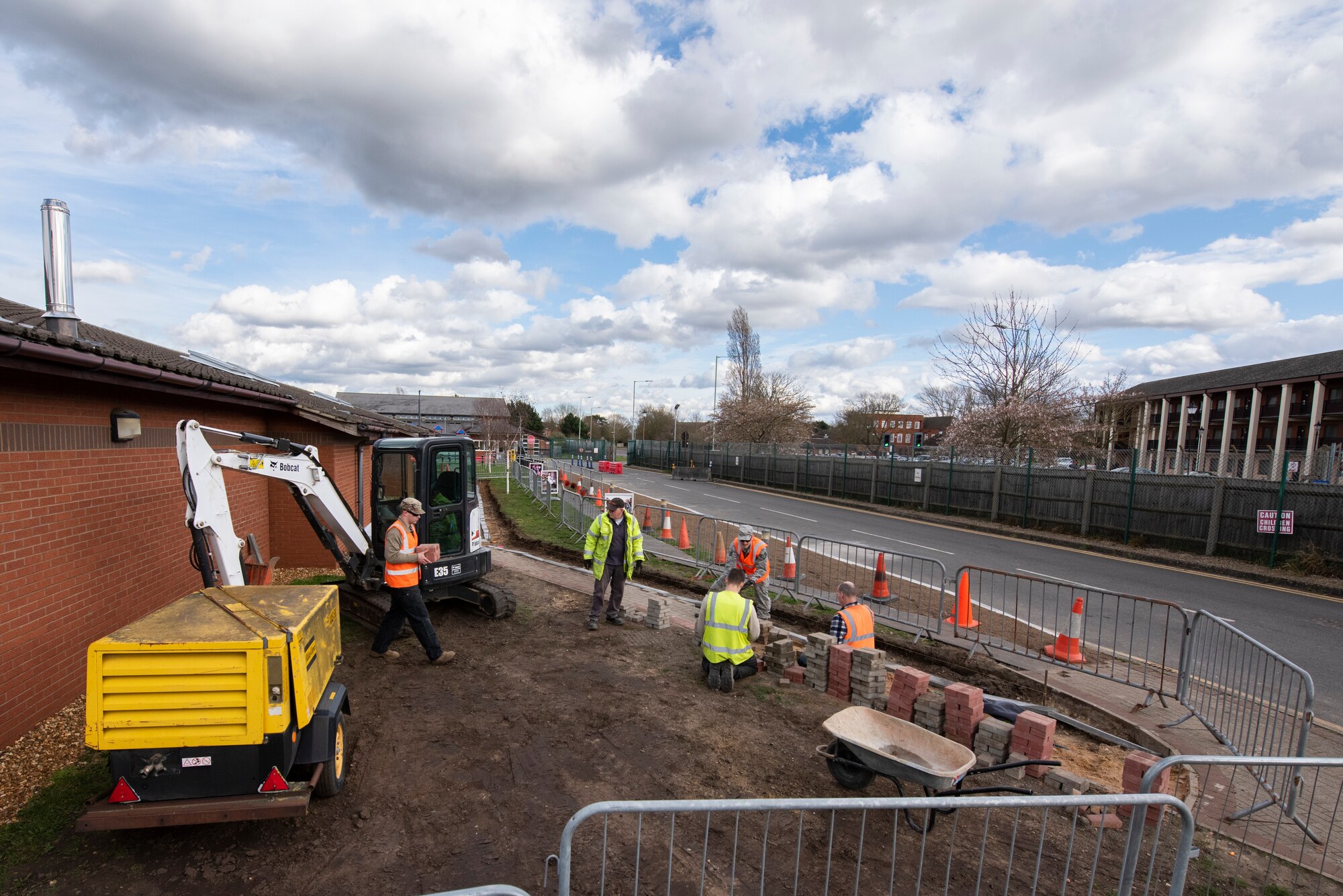 A group of 100th Civil Engineer Squadron pavements and construction equipment Airmen work to expand a sidewalk near the base child development center March 11, 2020, at RAF Mildenhall, England. The Airmen, known as “Dirt Boyz”, work on various infrastructure projects necessary for the functioning of the base. (U.S. Air Force photo by Airman 1st Class Joseph Barron)