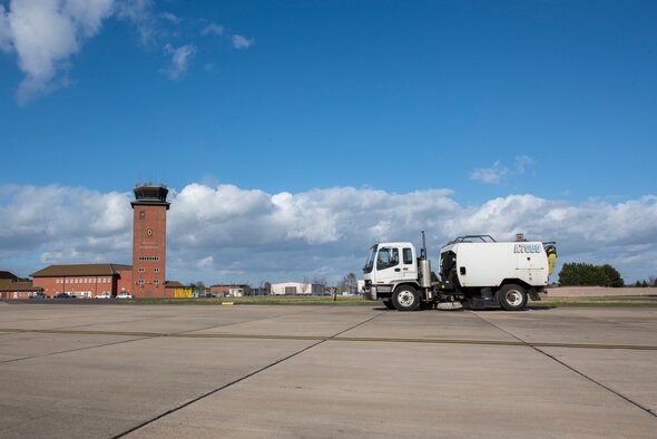 An airfield sweeper drives across the flight line March 12, 2020, at RAF Mildenhall, England. The 100th Civil Engineer Squadron pavements and construction equipment shop clears the flight line daily of foreign object debris. (U.S. Air Force photo by Airman 1st Class Joseph Barron)