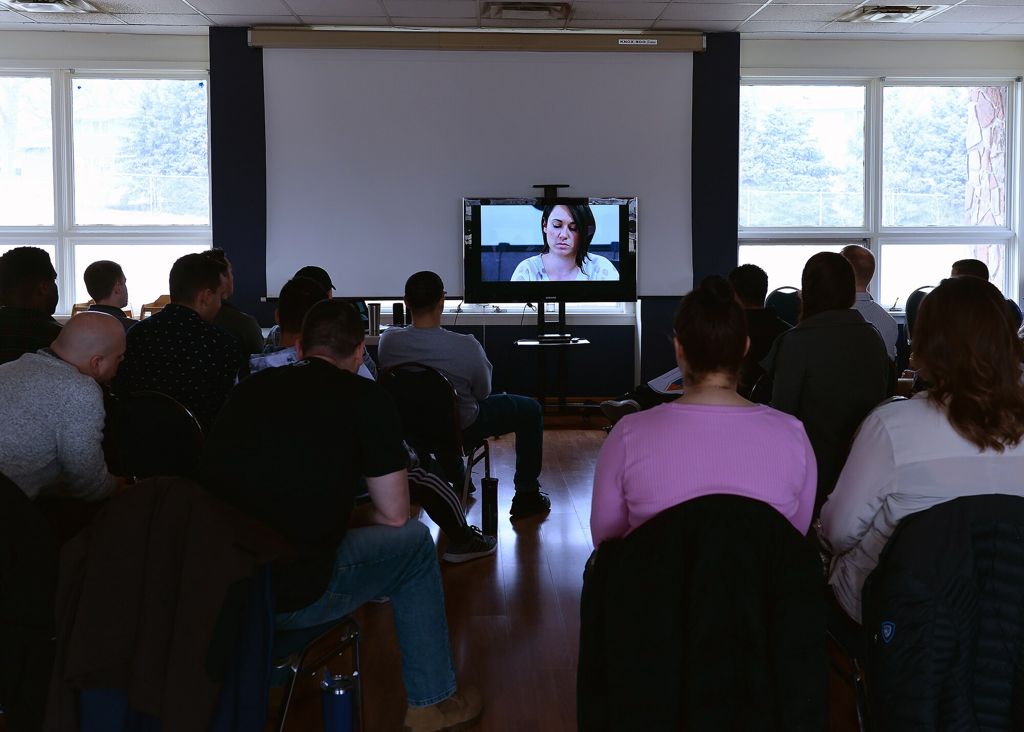 A picture of students watching a video in a classroom.