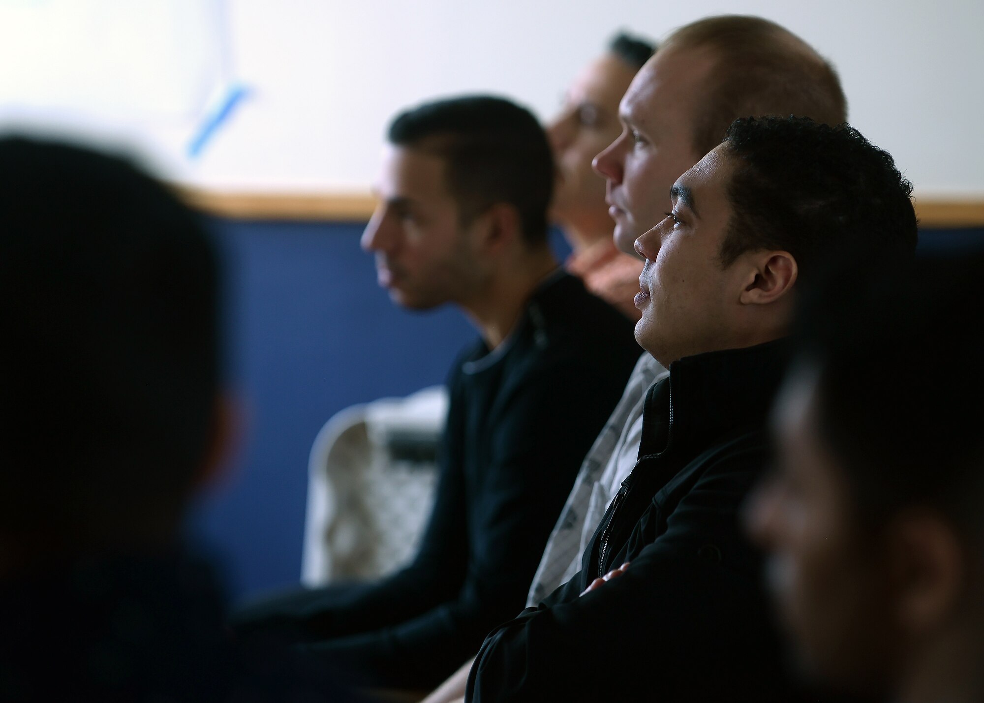 A picture of students watching a video in a classroom.