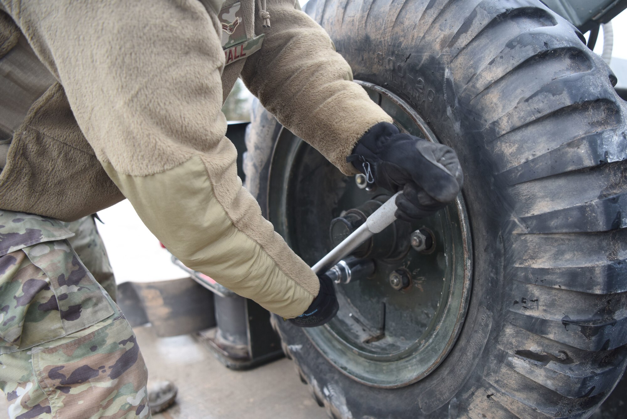 U.S. Airman 1st Class Phillip Wall, 36th Civil Engineer Squadron electrical power production technician, uses a tire iron to remove a tire on a mobile aircraft arresting system at Ramstein Air Base, Germany, March 10, 2020. The training taught Airmen how to effectively build and use mobile aircraft arresting systems, which are used to rapidly decrease the speed of aircraft as they land.