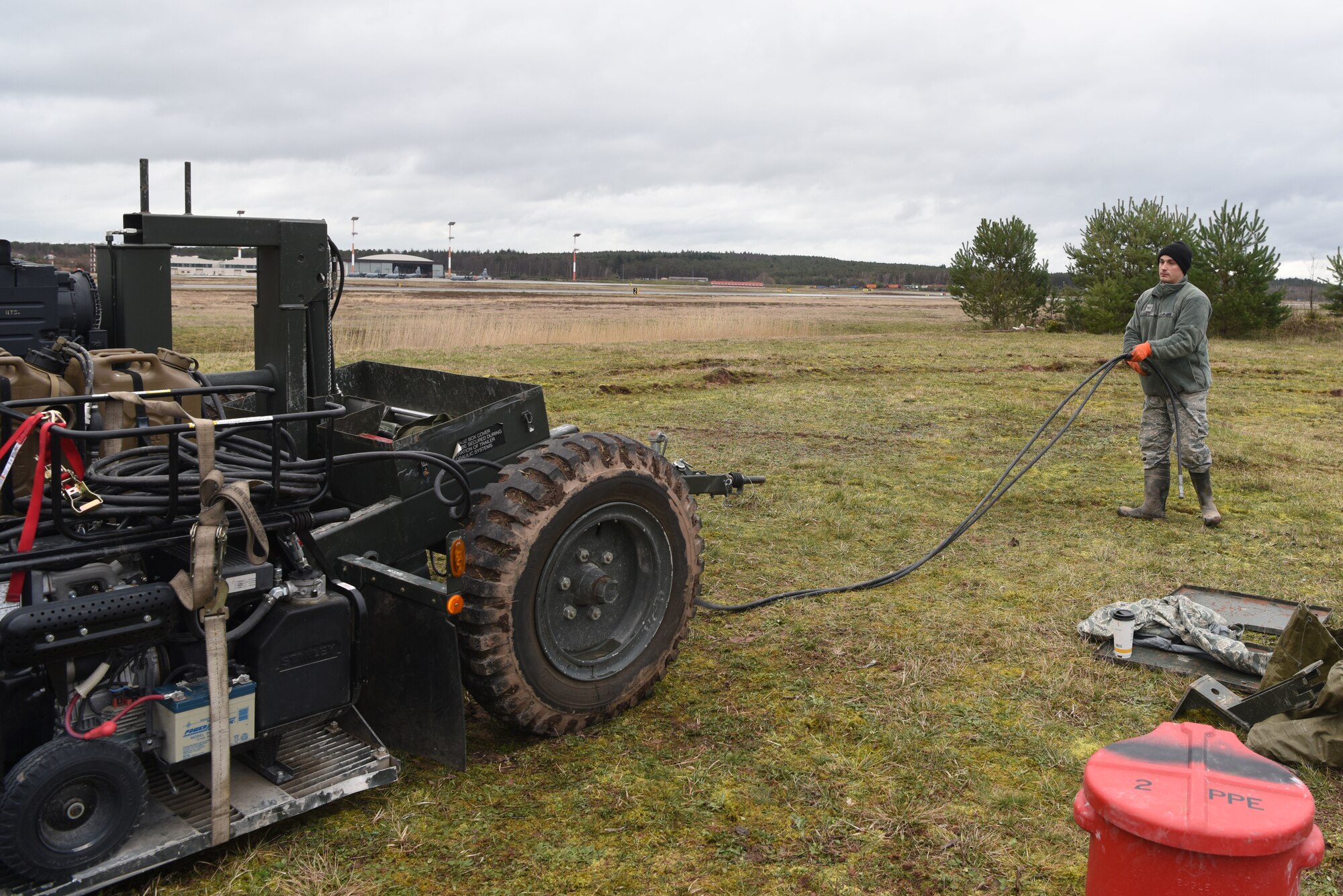 U.S. Air Force Senior Airman Sean Fauss, 932nd Civil Engineer Squadron electrical power production technician, stretches out an electrical line on a mobile aircraft arresting system at Ramstein Air Base, Germany, March 10, 2020. The 435th Contingency Response Squadron instructors taught Airmen from various Air Force civil engineer units how to setup and breakdown mobile aircraft arresting systems on varying terrain. The training taught Airmen how to effectively build and use mobile aircraft arresting systems, which are used to rapidly decrease the speed of aircraft as they land.