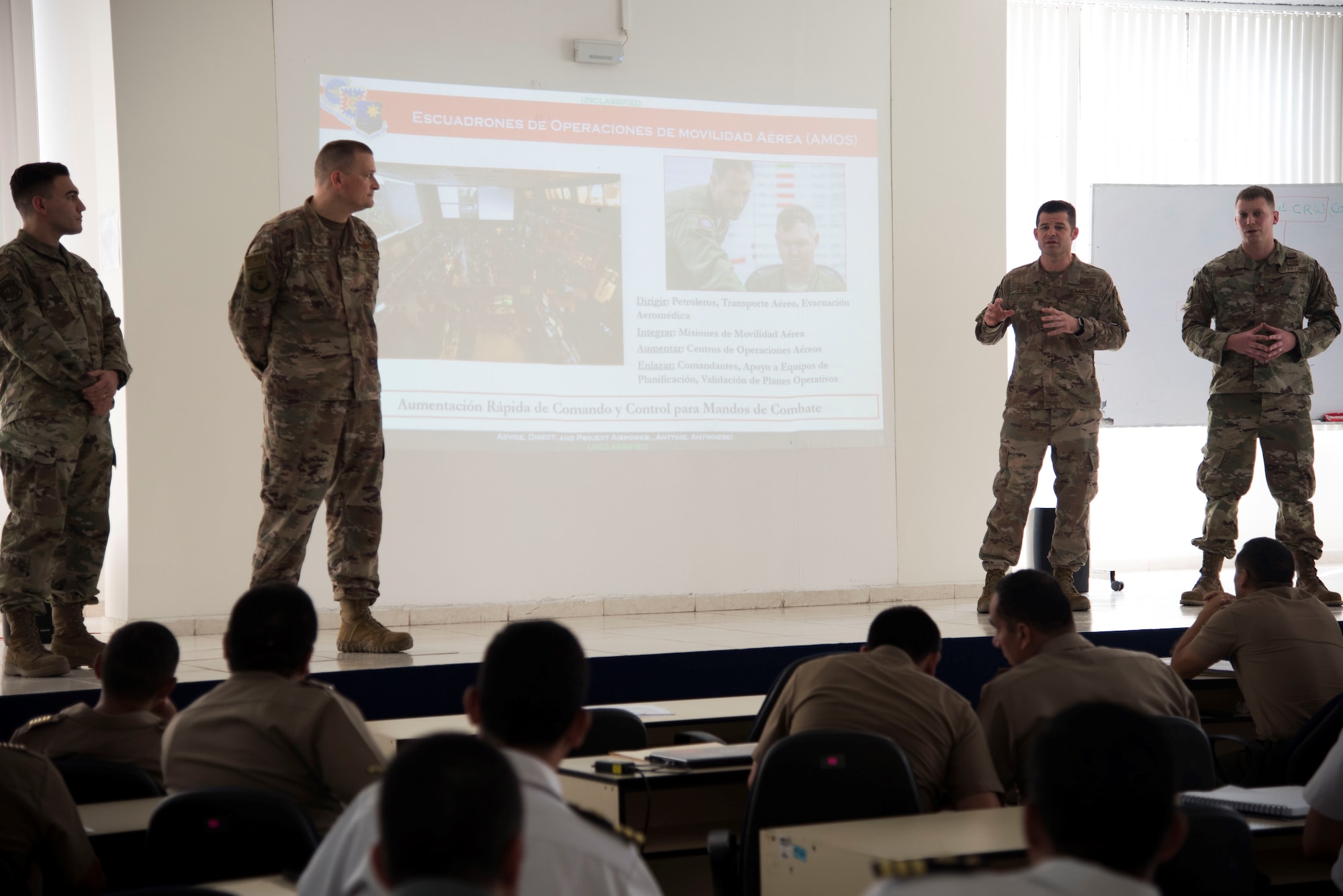 Col. Doug Jackson (left), 621st Contingency Response Wing commander, and Chief Master Sgt. Tony Jenkins 621st CRW command chief, deliver a presentation at the Joint School of the Armed Forces, Lima, Peru, March 3, 2020. The CRW leadership team was in Peru to observe aerial logistics training conducted by the 571st Mobility Support Advisory Squadron.