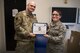 Master Sgt. Anthony Poulin, 66th Wing Staff Agency first sergeant, presents the Diamond Sharp award to Airman 1st Class Alexandra Berumen-Alcaraz, 66th Air Base Group commanders support staff administrative specialist at Hanscom Air Force Base, Mass. March. 11.. The Diamond Sharp program, adopted by the First Sergeant Council, aims to recognize personnel in the grades of Airmen Basic through Technical Sergeant who display the highest standards of professionalism and pride. The council also recognized Airman 1st Class John O’Neill, Joint Personal Property Shipping Office-Northeast movement support technician. (U.S. Air Force photo by Jerry Saslav)