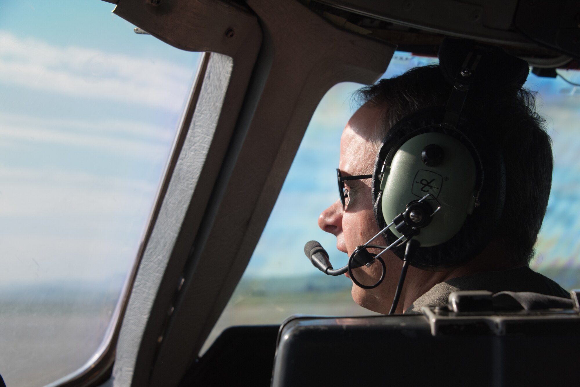 A KC-10 Extender pilot looks out the window of the flight deck