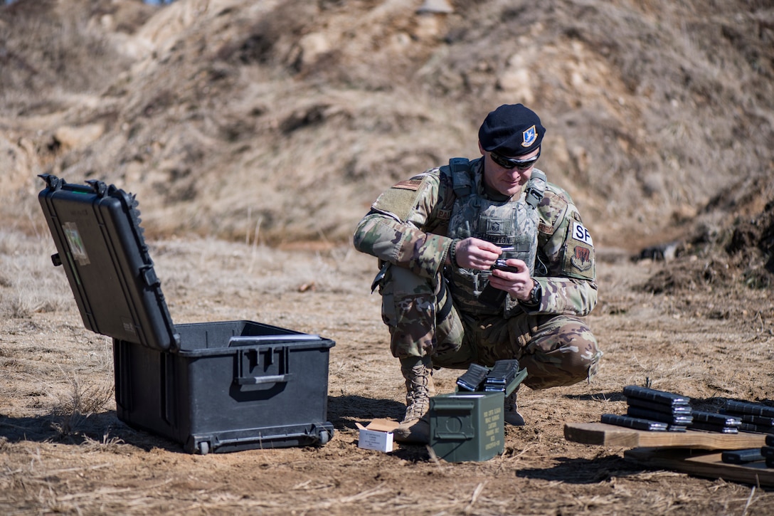 Master Sgt. loads magazines during "shoot, move and communicate" drills