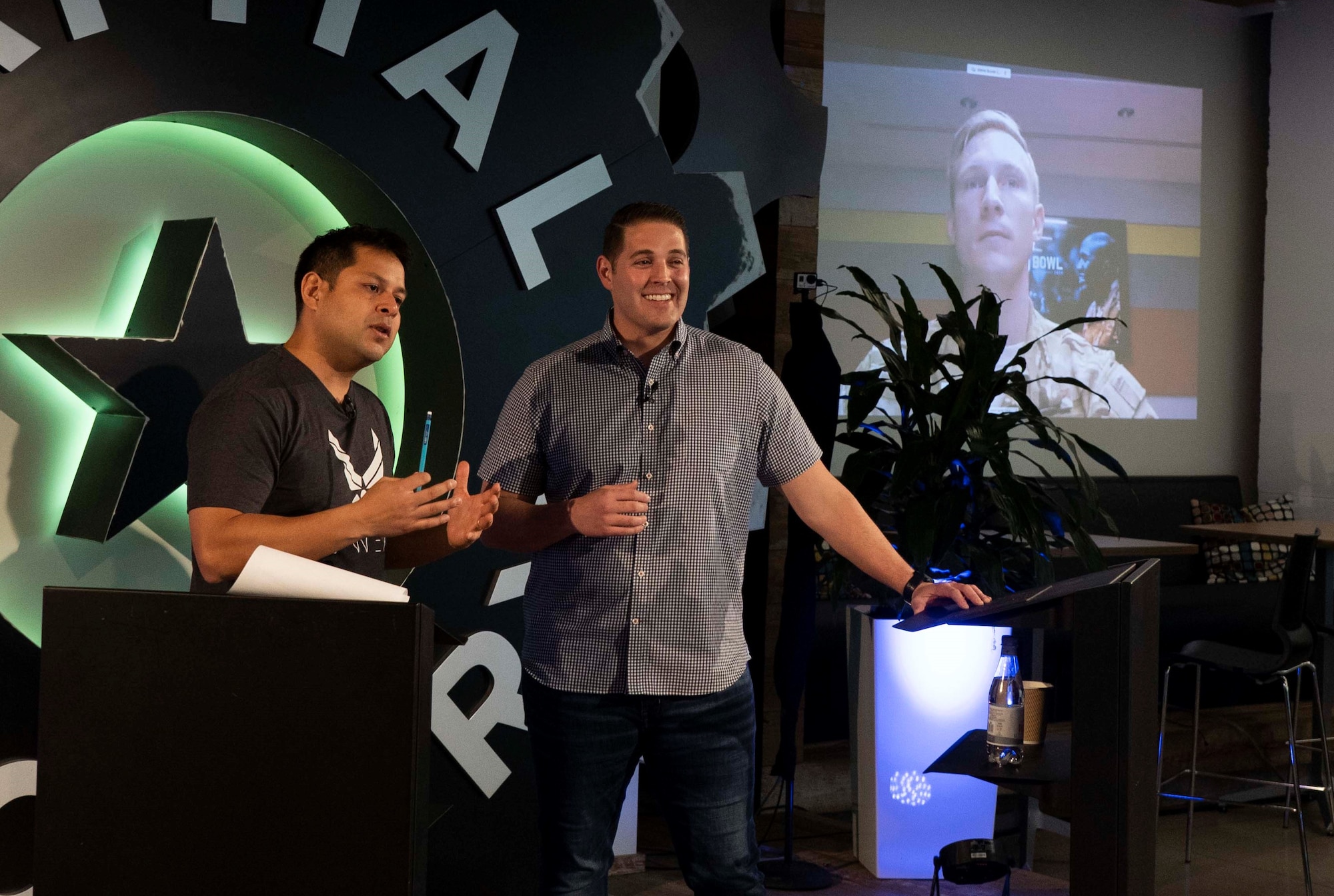 Maj. Tony Perez, left, AFWERX Spark lead, and Maj. Kinsley Jordan, Vance Air Force Base Spark Cell lead, speak during the virtual Spark Collider and Pitch Bowl event in Austin, Texas, March 12, 2020. In the span of three days, the Air Force and its joint partners quickly pivoted to a one-day virtual mega-event including keynotes, presentations and collaborative engagements with more than 2000 attendees from government, industry and academia. (U.S. Air Force photo by Staff Sgt. Jordyn Fetter)