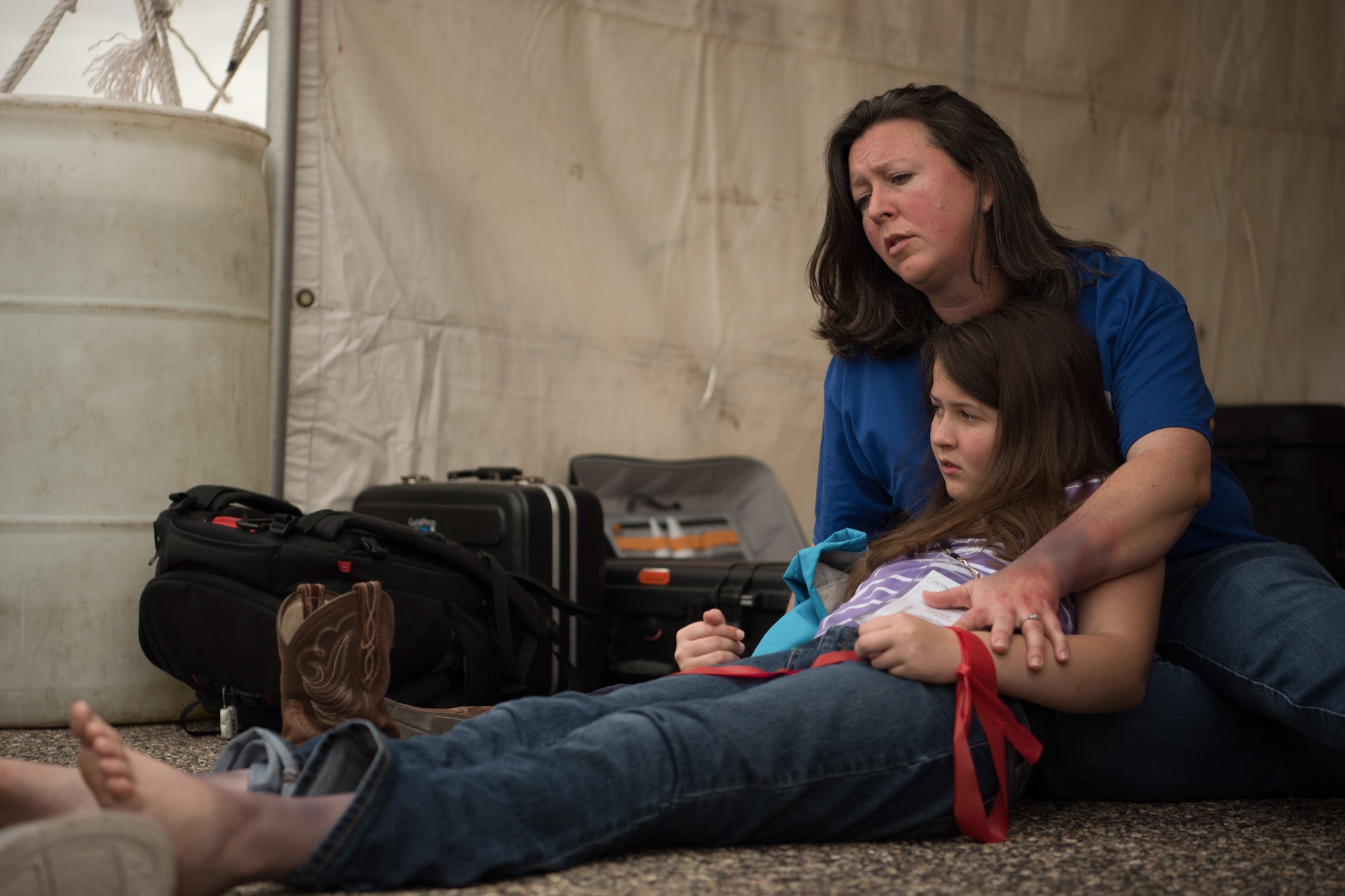 Two actors playing injured passengers wait in triage during an emergency services drill at Tucson International Airport, Ariz., March 10, 2020. Around 300 people, including volunteer actors, participated in the training exercise. (U.S. Air Force photo by Senior Airman Aubrey Pomares)