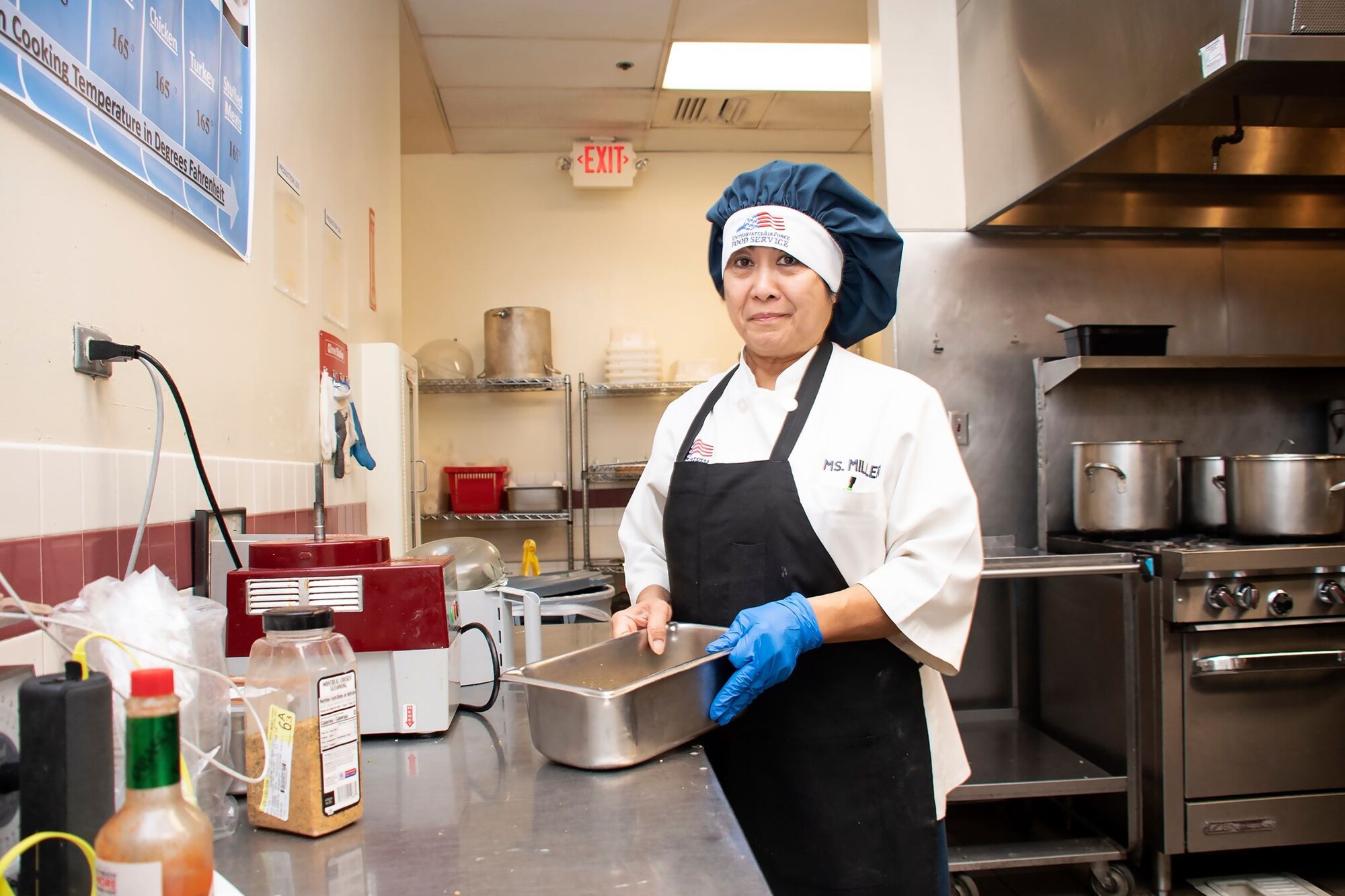 Praxedes Miller, 60th Force Support Squadron cook, prepares the lunch service March 11, 2020, at Travis Air Force Base, California. Miller has worked at the base’s dining facility for 31 years. (U.S. Air Force photo by Senior Airman Christian Conrad)