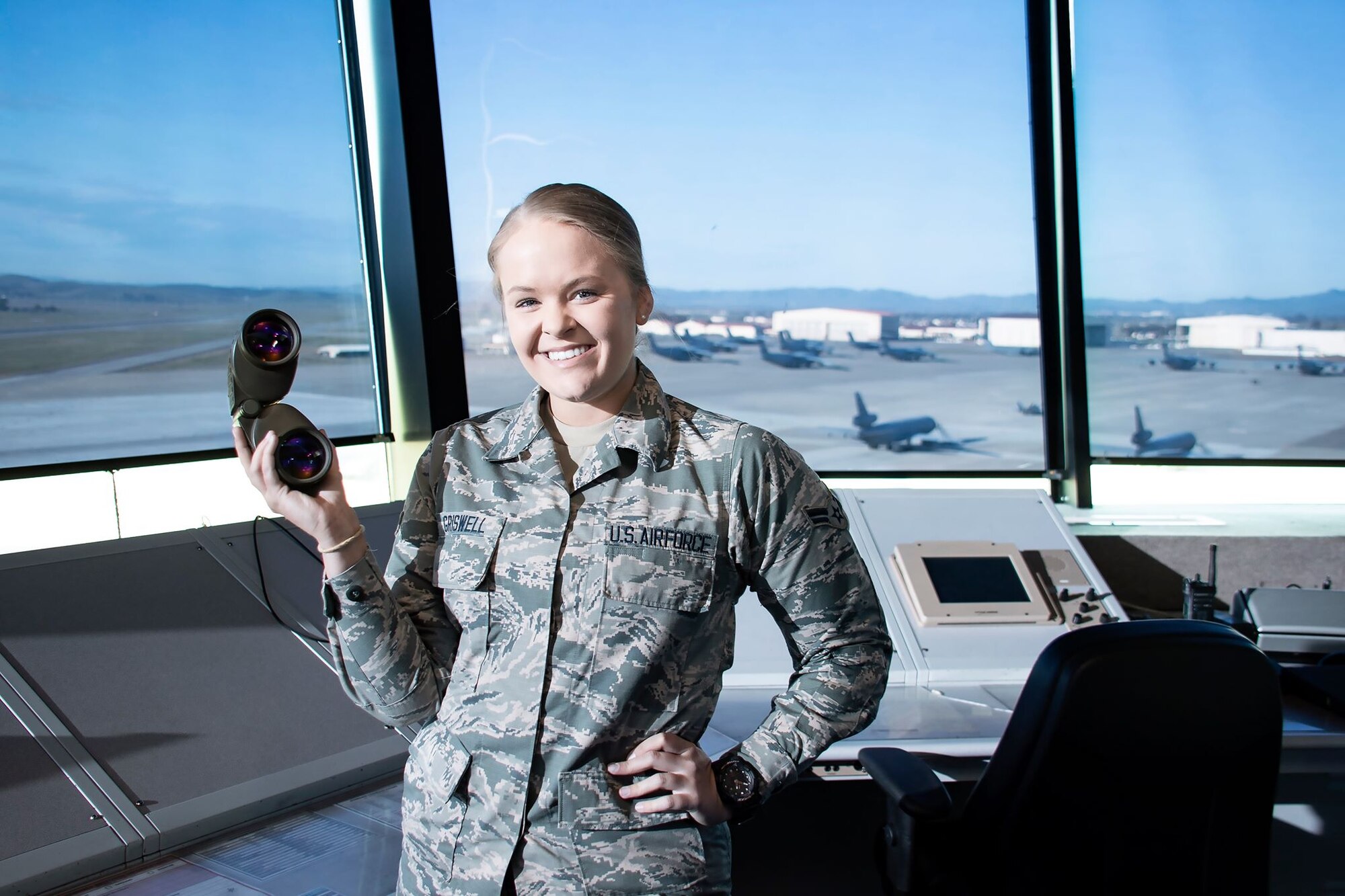 U.S. Air Force Airman 1st Class Bethany Griswell, 60th Operation Support Squadron air traffic controller apprentice, poses for a photo March 11, 2020, at Travis Air Force Base, California. The 60th OSS coordinates the take-off, landing and taxiing of Travis aircraft in a safe and expeditious manner. (U.S. Air Force photo by Senior Airman Christian Conrad)