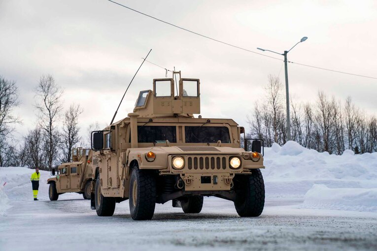 Marines drive a military vehicle.