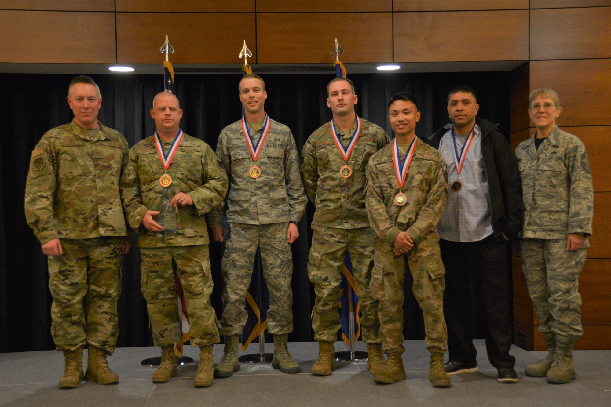 The 477th Fighter Group commander and superintendent join the 2019 annual winners for a group photo.