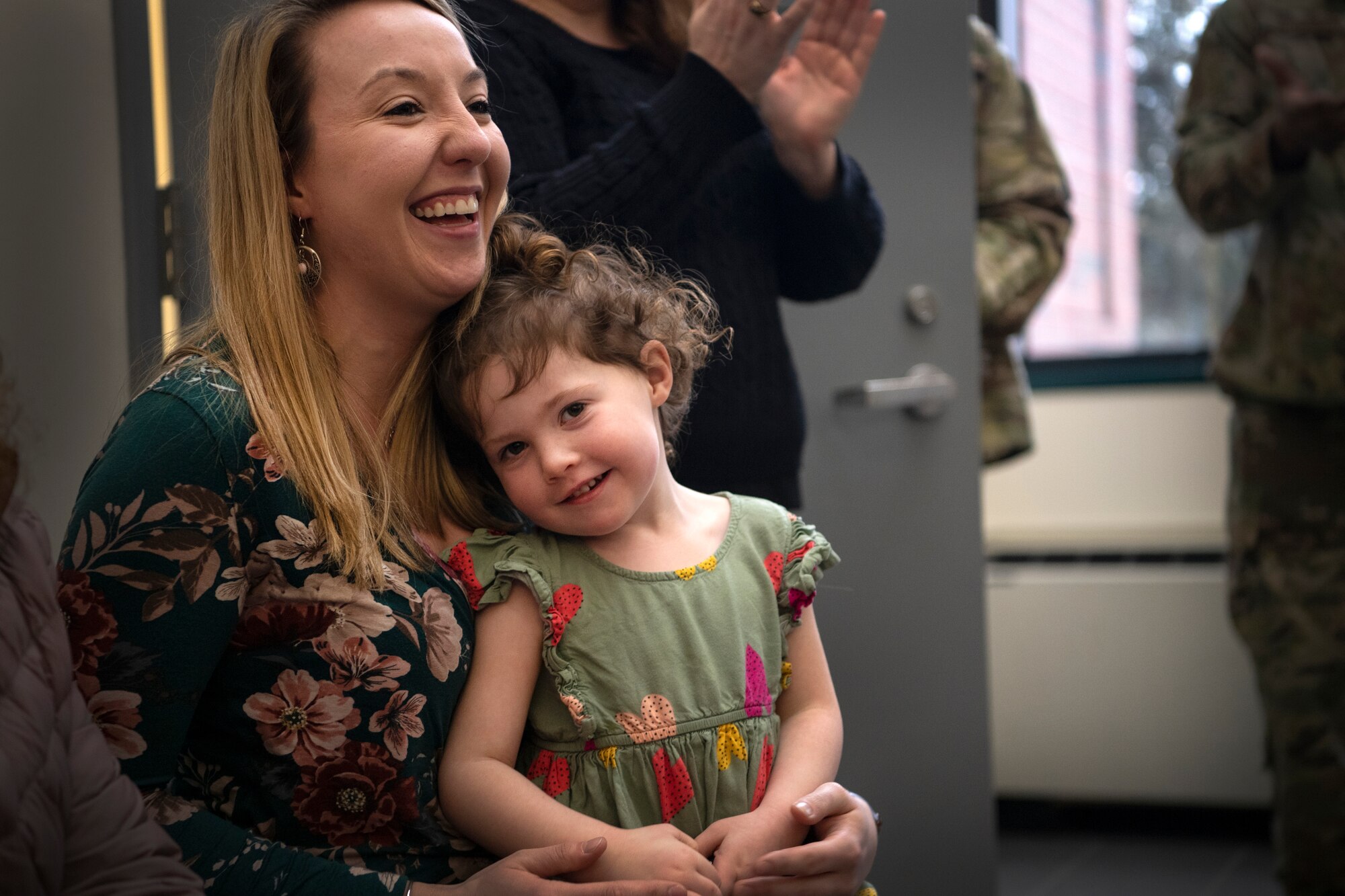 Kelly Chadbourne, wife of Staff Sgt. Humphrey Chadbourne, 66th Security Forces Squadron patrolman, and their daughter, Cailyn, smile following Chadbourne’s Air Force Achievement Medal presentation at Hanscom Air Force Base, Mass., Feb. 10.  Sergeant Chadbourne received the award for his rapid and decisive actions taken earlier this year, when he responded to a contractor suffering a heart attack while on base. (U.S. Air Force photo by Lauren Russell)