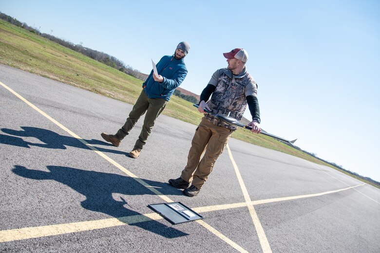 Brian Roden, left, a project manager and civil engineer with the U.S. Army Engineering and Support Center, Huntsville, works with Ryan Strange, research physical scientist with the U.S. Army Corps of Engineers’ Aviation and Remote Systems Program and Huntsville Center’s Unmanned Aircraft Systems Site Development Branch, to calibrate a sensor on the senseFly eBee X fixed-wing unmanned aircraft system before takeoff at the Rocket City Radio Controllers complex in southeast Huntsville, Alabama, during an unmanned aircraft systems capabilities review Feb. 27, 2020.
