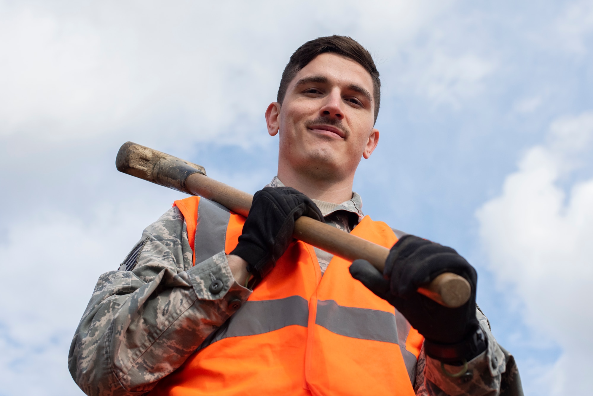 Staff Sgt. Rihlen Mital, 100th Civil Engineer Squadron pavements and construction equipment journeyman, poses for a photo as a “Dirt Boy” during a sidewalk construction project March 11, 2020, at RAF Mildenhall, England. “Dirt Boyz” work in a variety of weather conditions when completing construction projects in support of the mission. (U.S. Air Force photo by Airman 1st Class Joseph Barron)