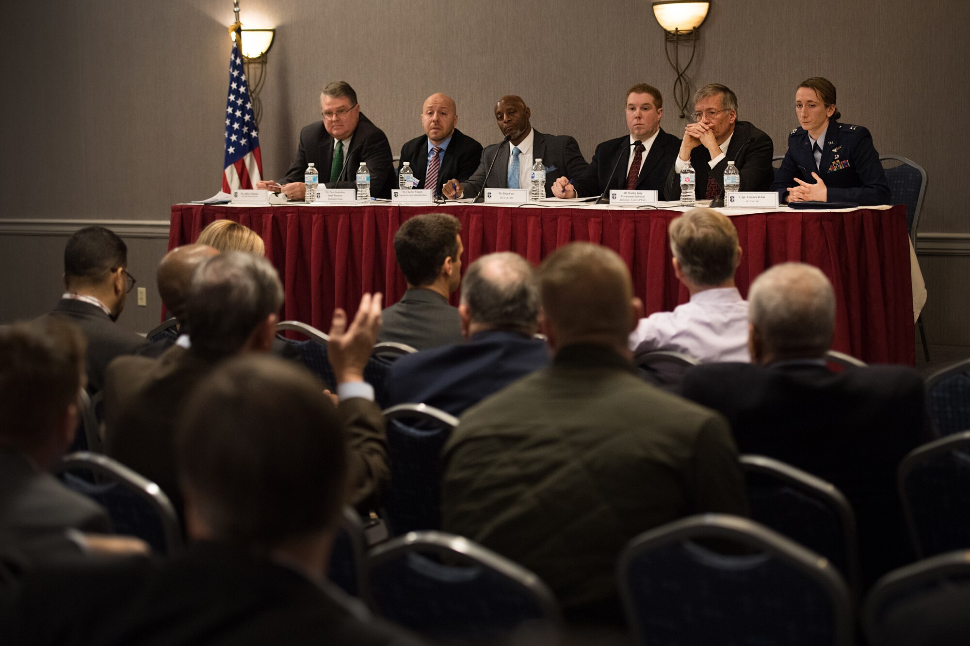 Jeffery Emmons, Small Business Office-Hanscom, from left, Peter Kontakos, Small Business Administration -Massachusetts District Office deputy district director, Charles Wingate, General Services Administration Information Technology Commodity Division branch chief,  Brian Carr, Command, Control, Communications, Intelligence and Networks Directorate Innovation director , Stanley Grip, Massachusetts Procurement Technical Assistance Center procurement specialist, and Capt. Amanda Rebhi, Program Executive Office-Digital Innovation director, take questions from the audience during the  Hanscom Small Business Panel in Newton, Mass., March 9. The panel discussed support and opportunities for small and non-traditional businesses looking to provide services to the government. (U.S. Air Force photo by Jerry Saslav)