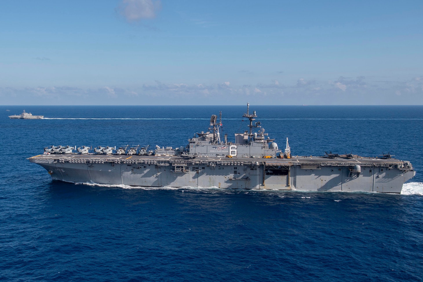 Amphibious assault ship USS America (LHA 6) sails alongside littoral combat ship USS Gabrielle Giffords (LCS 10).