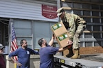 New York Army National Guard Pfc. Michael Ulrichy, assigned to the 4th Finance Detachment of the 53rd Troop Command, distributes hand sanitizer to members of the Mamaroneck Highway Department near New Rochelle, N.Y., March 13, 2020. Ulrichy and more than 250 other New York National Guardsmen were helping a New York State Department of Health task force to contain and mitigate the COVID-19 virus cluster outbreak in Westchester County, N.Y.