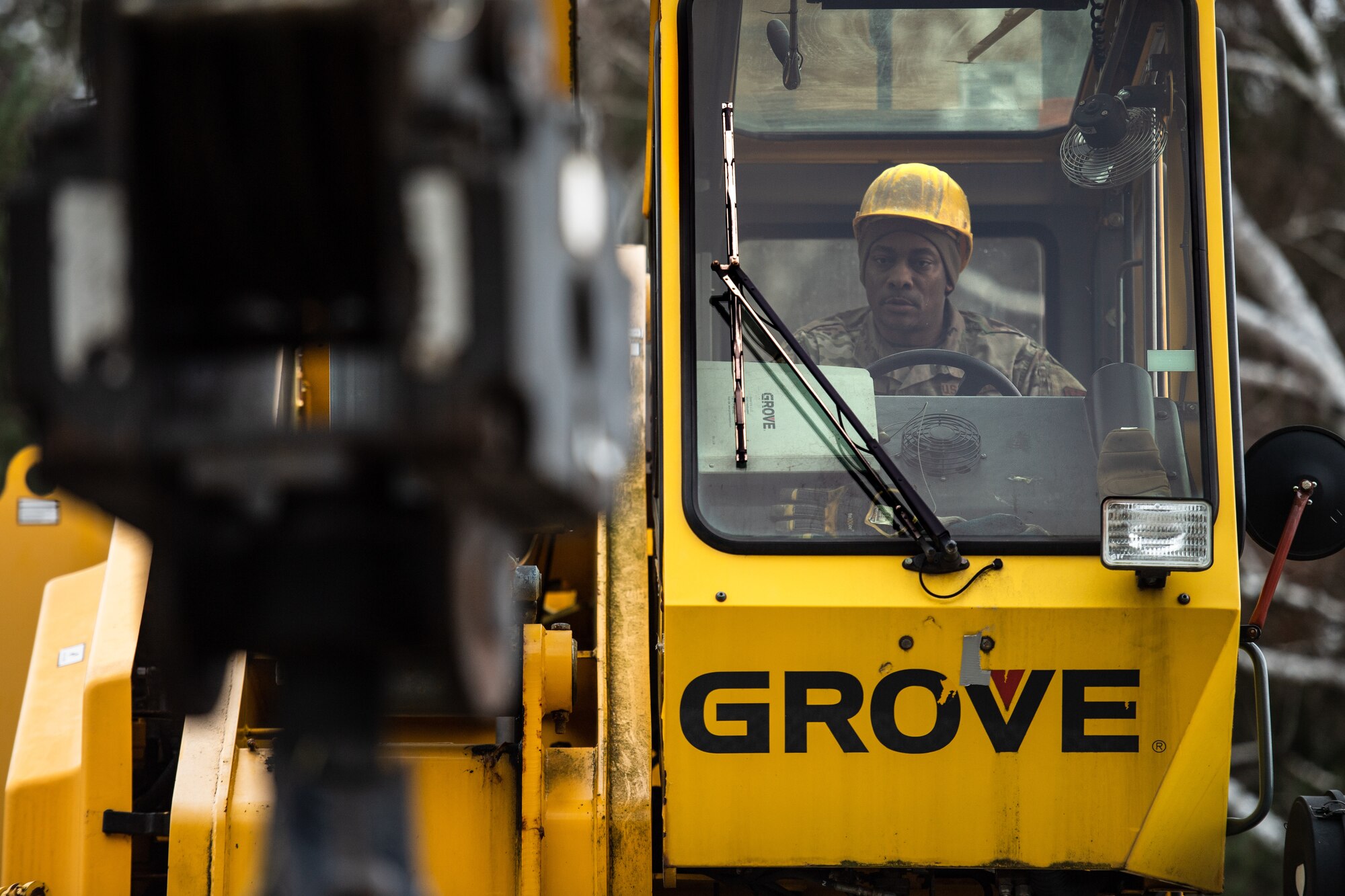 Photo of Airman operating a crane