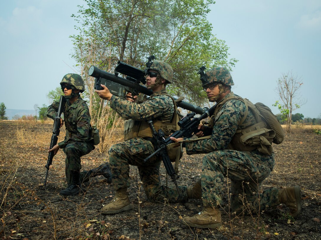 A Royal Thai Marine and a U.S. Marine hold security as a U.S. Marine sights in with an FIM-92A Stinger missile launcher during a combined joint High Mobility Rocket System rapid insertion as part of Cobra Gold 2020, at Chandy Range, Kingdom of Thailand, March 2.