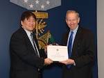 Frank Tse receives a Distinguished Service Award for his work with TTCP Weapons Technical Panel 4 from Dr. Michael Griffin, Undersecretary of Defense for Research and Engineering during the 2019 Science and Technology International Award Ceremony at the Pentagon, March 4. (U.S. Army photo by Darrell Hudson/RELEASED)