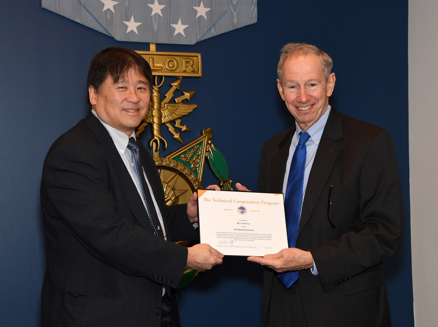 Frank Tse receives a Distinguished Service Award for his work with TTCP Weapons Technical Panel 4 from Dr. Michael Griffin, Undersecretary of Defense for Research and Engineering during the 2019 Science and Technology International Award Ceremony at the Pentagon, March 4. (U.S. Army photo by Darrell Hudson/RELEASED)