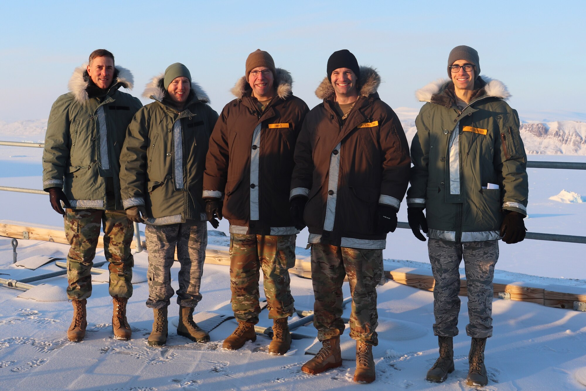 THULE AIR BASE, Greenland – Col. Thomas Falzarano, 21st Space Wing commander (far left), Col. James Smith, 50th SW commander (second to left), Col. Timothy Bos, 821st Air Base Group commander (center), Lt. Col. Jared Smith, 12th Space Warning Squadron commander (second from right), and Capt. Peter Amaddio, 821st Space Control Squadron civil engineer (far right), pose on top of the 12th SWS facility at Thule Air Base, Greenland, on Feb. 27, 2020. Both wing commanders traveled to the Arctic to spend two days with the men and women at Thule to learn about their duties and listen to their challenges and concerns. (Courtesy Photo)