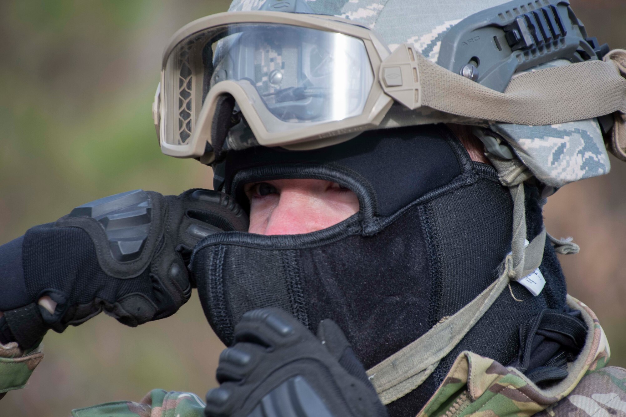 Photo of Airman adjusting a face mask.