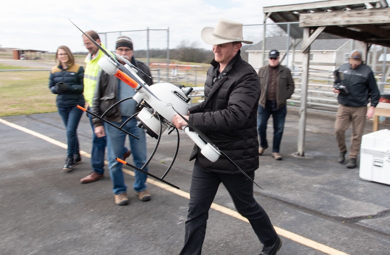 Navigational Electronics Inc. demonstrator and subject-matter expert Ross Kenney carries the Microdrones MD4-1000 unmanned aircraft system to a takeoff point during a capabilities review at the Rocket City Radio Controllers complex in southeast Huntsville, Alabama, Feb. 27, 2020.