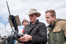 Navigational Electronics Inc. demonstrator and subject-matter expert Ross Kenney controls a Microdrones MD4-1000 unmanned aircraft system and discusses its features with two members of the U.S. Army Engineering and Support Center Huntsville – William Noel, left, project manager, and Benton Williams, geophysicist – during a capabilities review for three unmanned aircraft systems Feb. 27 at the Rocket City Radio Controllers complex in southeast Huntsville, Alabama. Williams works in the Geosciences Branch of the Engineering Directorate, while Noel works in the Ordnance and Explosives Design Center.