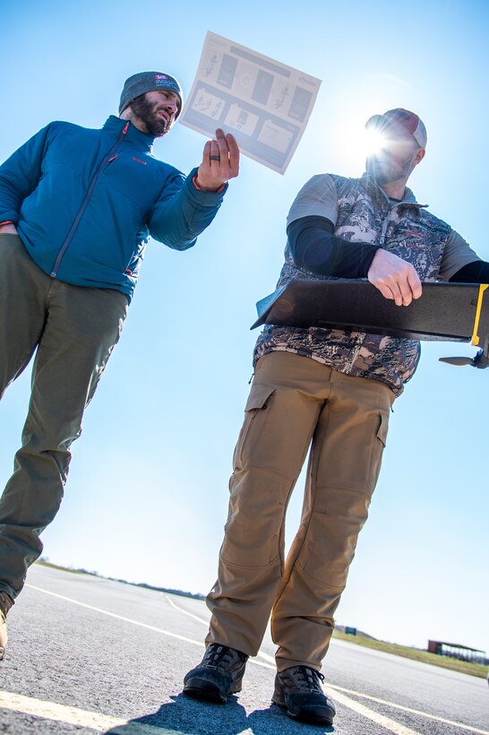 Brian Roden, left, a project manager and civil engineer with the U.S. Army Engineering and Support Center, Huntsville, works with Ryan Strange, research physical scientist with the U.S. Army Corps of Engineers’ Aviation and Remote Systems Program and Huntsville Center’s Unmanned Aircraft Systems Site Development Branch, to calibrate a sensor on the senseFly eBee X fixed-wing unmanned aircraft system before takeoff at the Rocket City Radio Controllers complex in southeast Huntsville, Alabama, during an unmanned aircraft systems capabilities review Feb. 27, 2020.