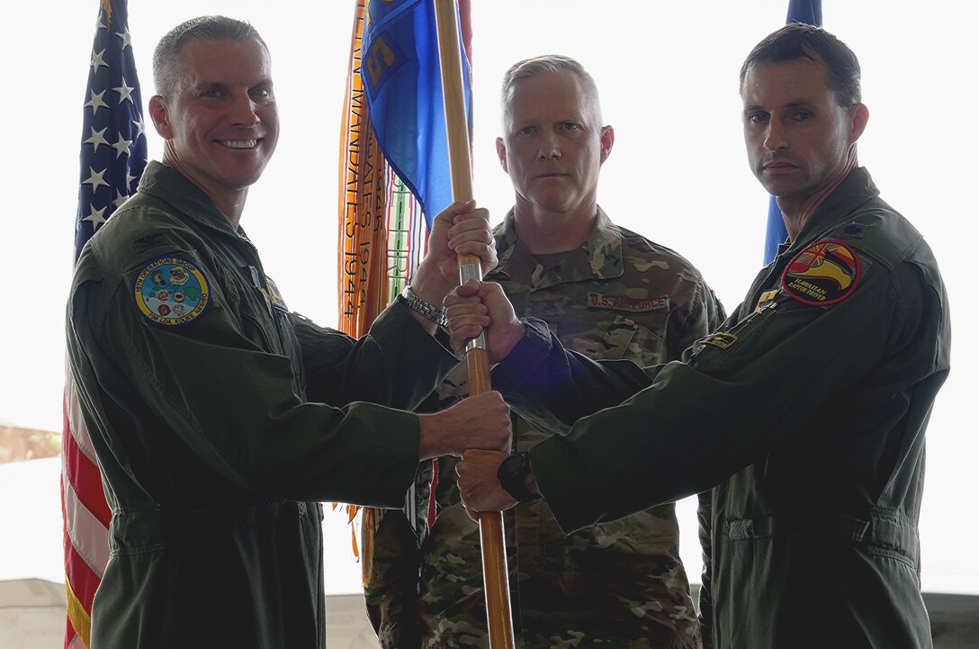 Col. Scott Berndt, 15th Operations Group commander, receives the guidon from Lt. Col. Graham Stewart at the 19th Fighter Squadron Change of Command Ceremony at Joint Base Pearl Harbor-Hickam, Hawaii, March 13, 2020. The 19th Fighter Squadron is the first active duty associate unit flying the Raptor and is a member of the Total Force team with the Hawaiian Raptors. With the F-22 and the Hawaiian Raptors, the 19th Fighter Squadron continues its legacy and commitment to provide air dominance in the Indo-Pacific as one of the oldest squadrons in the United States Air Force. (U.S. Air Force photo by Airman 1st Class Erin Baxter)