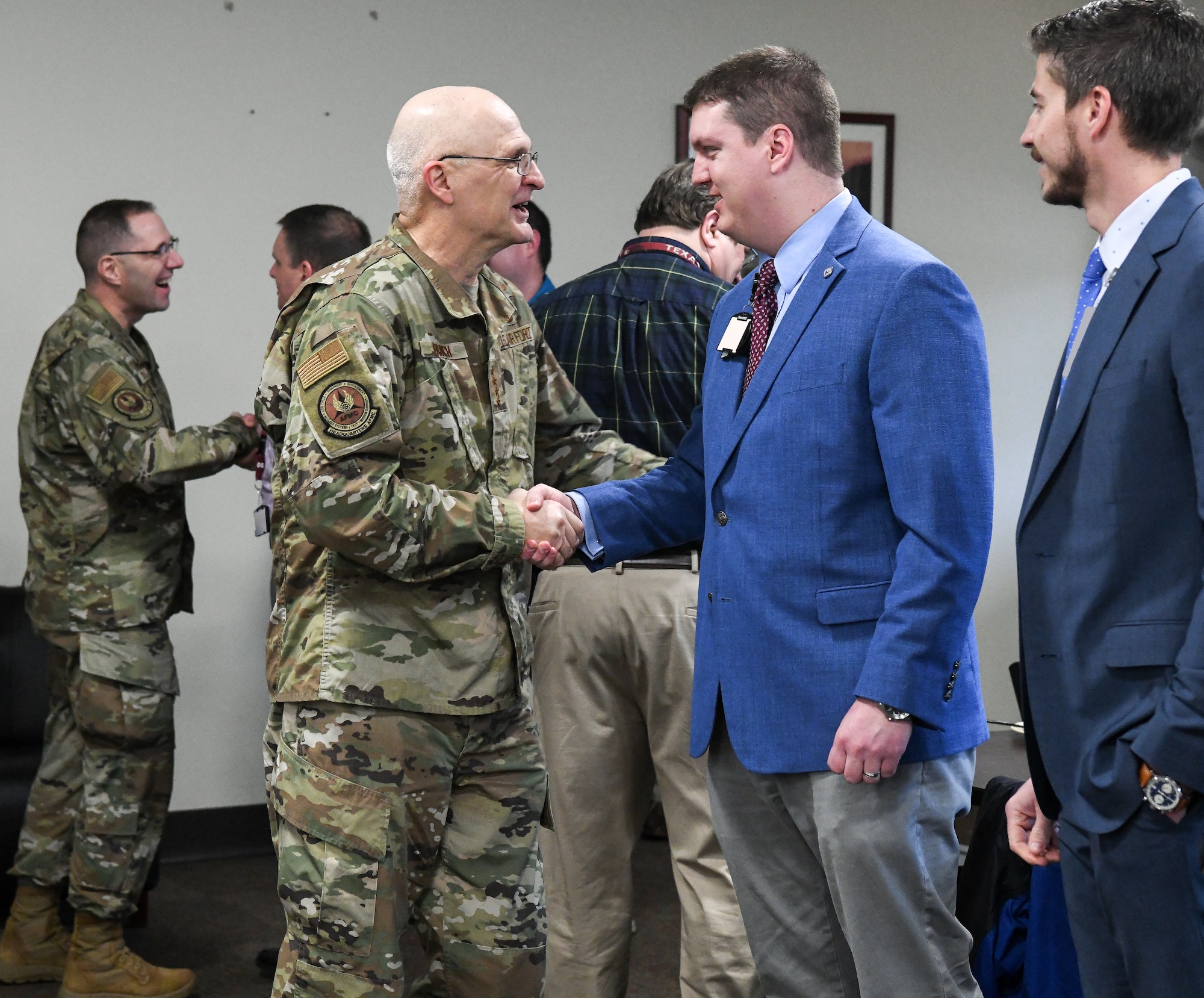 Gen. Arnold W. Bunch, Jr., commander, Air Force Materiel Command, shakes hands with John Claybrook, an Arnold Engineering Development Complex (AEDC) team member, Feb. 7, 2020, at Arnold Air Force Base, Tenn. Bunch had breakfast with AEDC team members and fielded questions. (U.S. Air Force photo by Jill Pickett) (This image has been altered by obscuring badges for security purposes.)