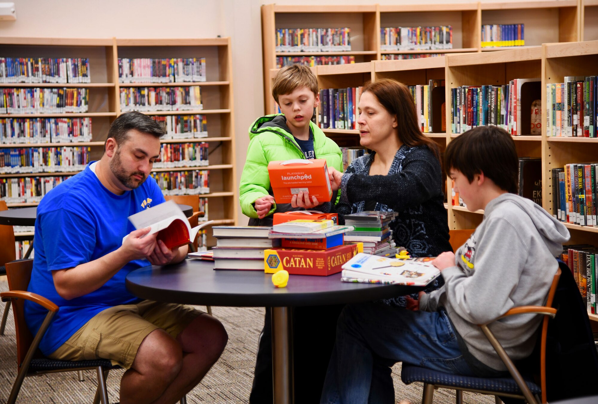 The Williams family takes some time to enjoy all the resources that the library on Peterson Air Force Base, Colorado has to offer on March 5, 2020. Brothers Collin and Ian Williams, frequent patrons, say they are excited about the new layout and hope people enjoy visiting the facility as much as they do.  (U.S. Air Force photo by Erica Blanton)