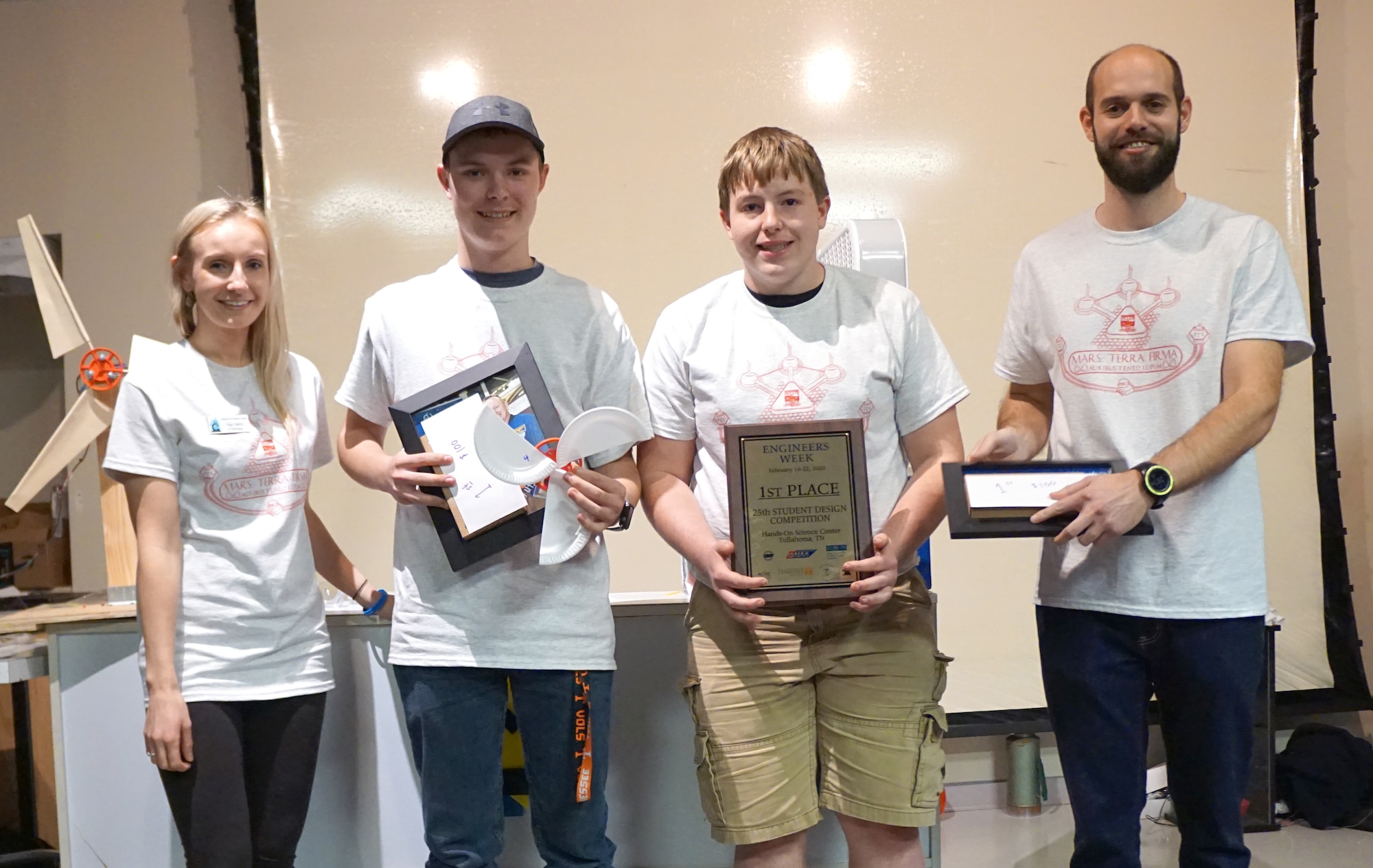 Grundy County High School students, pictured from second from left, Andrew Barrett and Luke Sweeney receive the first place award in the Student Design Competition Feb. 18, 2020, at the Hands-On Science Center in Tullahoma, Tenn. Also pictured are Olga Oakley, left, Air Force STEM outreach director, and Paul Ritter, right, an Arnold Engineering Development Complex team member and Student Design Competition volunteer, presenting the award. (Courtesy photo)