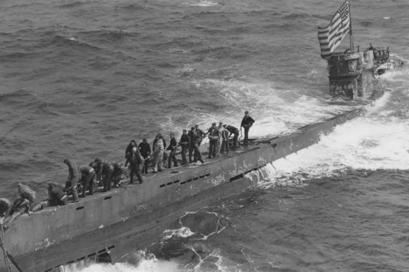 People walk on a submarine.