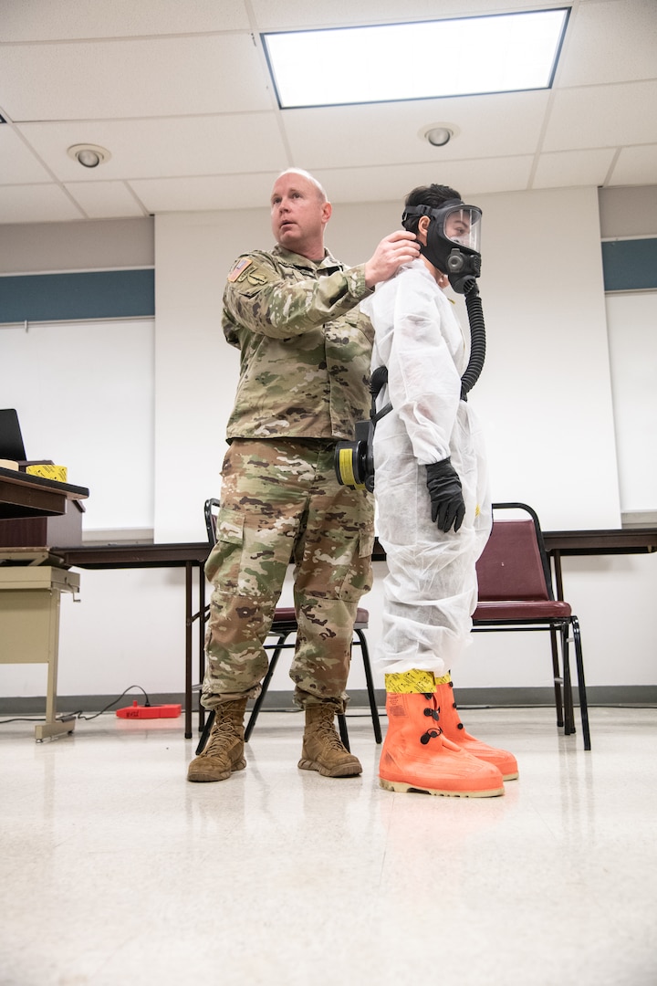 Photo caption for attached images: Members of the West Virginia National Guard's (WVNG) Chemical, Biological, Radiological, Nuclear and High Yield Explosive (CBRNE) Battalion, 35th Civil Support Team (CST) and the 35th CBRN Enhanced Response Force Package (CERFP) provide hands-on personal protective equipment (PPE) instruction to members of first responder agencies from Kentucky and West Virginia, March 16, 2020, in Huntington, W.Va. The just-in-time training was conducted in order to educate first responders on how to minimize cross-contamination through the proper wear of, “donning” and the procedures for “doffing” PPE. (U.S. Army National Guard photo by Edwin L. Wriston)