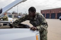 Navy Personnel Specialist 1st Class Abdul Amadu, assigned to the Joint Task Force Civil Support (JTF-CS) personnel department, performs a weekly maintenance check on one of the command’s deployable vehicles.